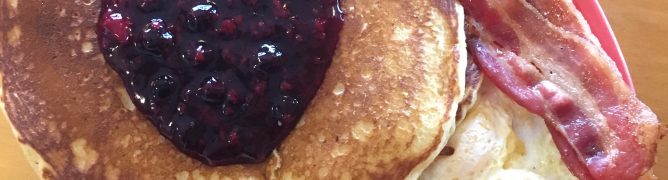 Corn cakes full house topped with blue berry compote